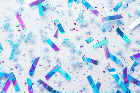 Colorful confetti and streamers on white background. Flat lay, top viewの素材