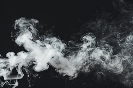 White steam on a black background. Copy space. Selective focus.の素材