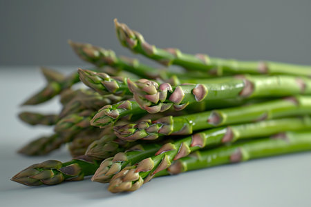 Bunch of fresh green asparagus on grey background. Close upの素材
