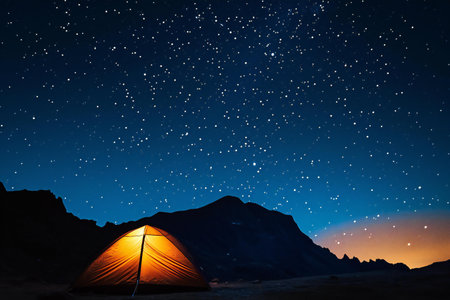 Camping in the mountains at night with starry sky and starsの素材