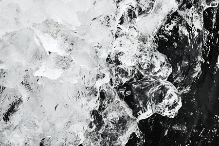 Ice cubes on black background. Close-up of frozen water.の素材