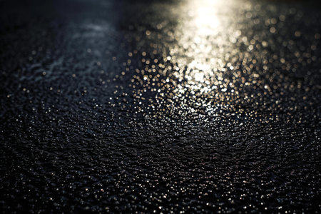 Water drops on a wet glass surface with sun rays. Abstract backgroundの素材