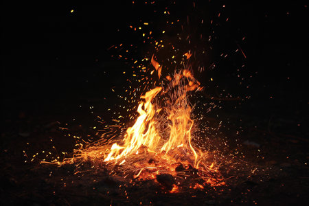 fire flames with sparks on a black background, closeup of photoの素材