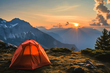 Camping on the top of the mountain in the rays of the setting sunの素材