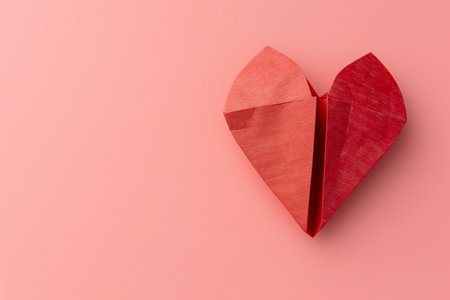 Red paper heart on a pink background. Valentine's day concept.の素材