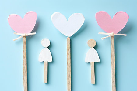 Wooden lollipops with paper hearts on blue background.の素材