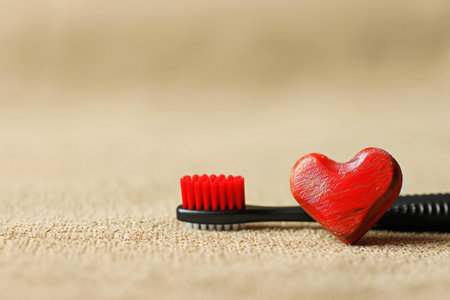 Red heart and toothbrush on brown background with copy space. Valentine's day concept.の素材