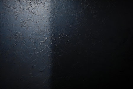 Black textured wall with light rays. Dark background and texture.の素材