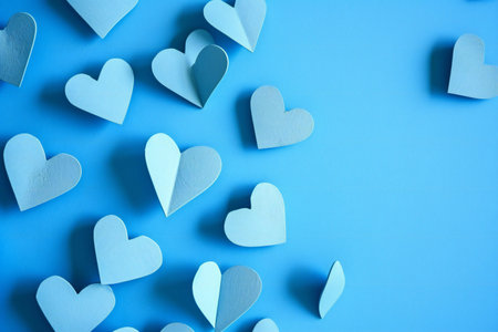 Blue paper hearts on a blue background. Valentine's day concept.の素材