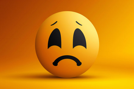 Emoticon with sad expression on orange background.の素材