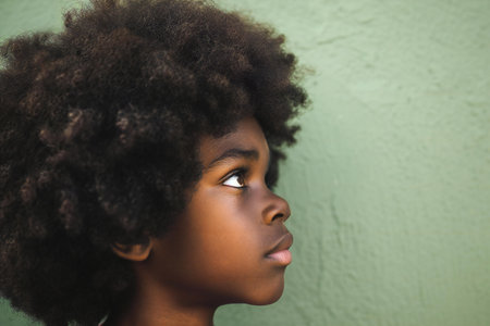 Close-up portrait of young african american woman looking awayの素材