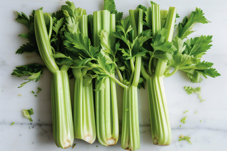 Fresh celery on white marble table. Top view, flat layの素材