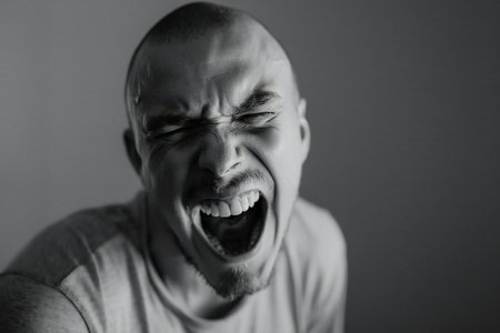 Portrait of an angry screaming man. Monochrome image.の素材