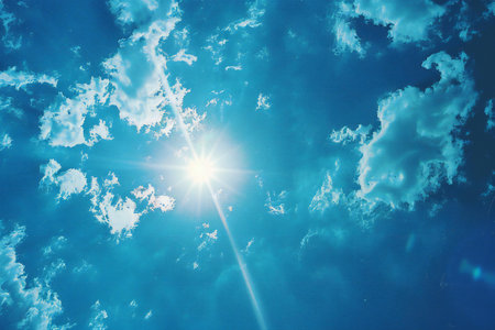 Blue sky with clouds and sun. Natural background. Copy space.の素材