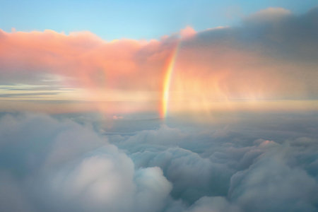 Beautiful rainbow in the sky above the clouds. Nature background.の素材