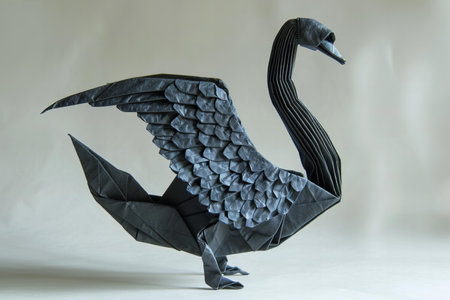black swan origami made from plasticine on a white backgroundの写真素材