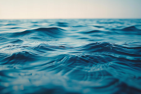 Close up of blue sea water surface with ripples and waves.