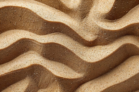 Sand texture background. Top view of sand surface with wave pattern.の写真素材