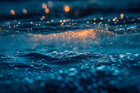 abstract background of water surface with bokeh defocused lightsの写真素材