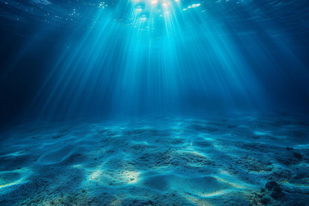 Underwater view of the coral reef with sun rays shining through the waterの写真素材
