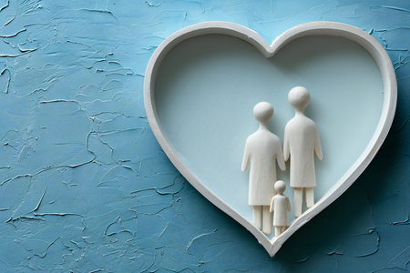 Paper family in heart-shaped frame on blue background, top viewの写真素材