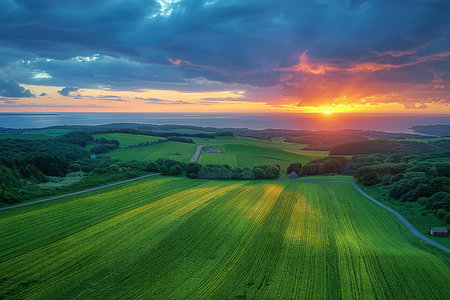 Aerial view of beautiful sunset over green field. Nature composition.