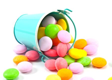 Bucket of colorful candy on white backgroundの写真素材