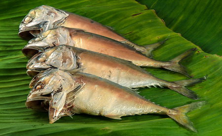 Steamed mackerel on banana leaves ready to be cooked