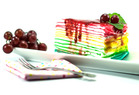 Rainbow crepe cake on white backgroundの写真素材