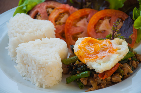 Rice topped with stir-fried pork and basil with egg, Thai styleの写真素材