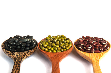 Beans in wood spoon on white backgroundの写真素材