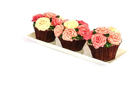Roses cupcake over white backgroundの写真素材