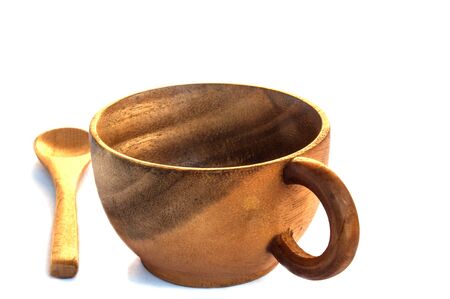 Empty wooden coffee cup and spoon on white backgroundの写真素材