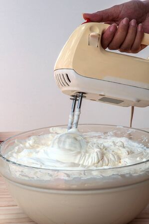 Making butter  cream cake using hand mixerの写真素材