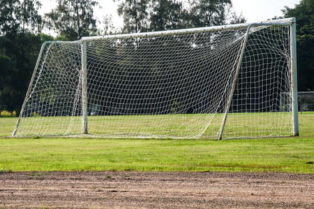 Football goals in the field with the tree backgroundの写真素材