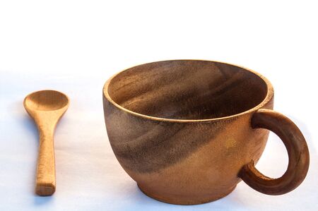 Empty wooden coffee cup and spoon on white backgroundの写真素材