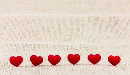 Small red hearts putting on sack for background useの写真素材