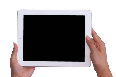 Isolated female hands holding and pushing old tablet in blank black screen to takewatch photo. Photo includes clipping paths at black screen and white background.の写真素材