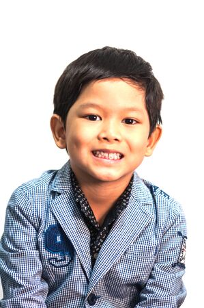 Asian 6 years old boy expresses happy smiling isolated over white  backgroundの写真素材