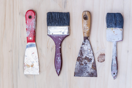Old painter brush set, hand tool, over white wooden backgroundの写真素材