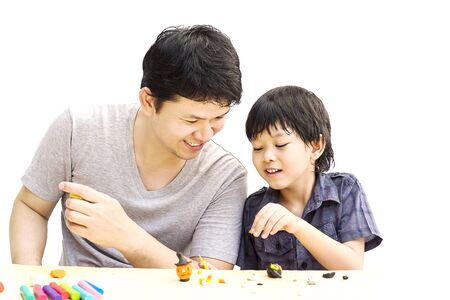 Father is playing Halloween clay with his son over white backgroundの写真素材