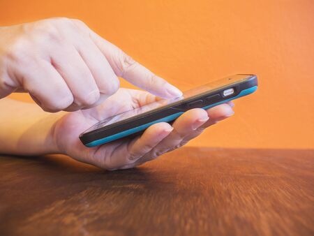 Lady's hands is using mobile phoneの写真素材