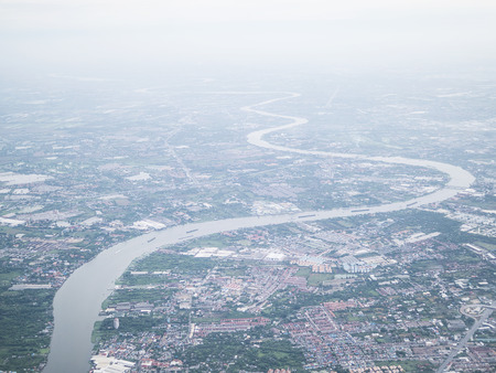 Soft focused of aerial view of Bangkok city and Chao Phraya river with morning fog overlay, capital of Thailandの写真素材