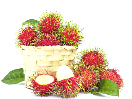 Fresh rambutan with weaved bamboo basket  isolated over white backgroundの写真素材