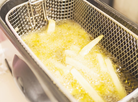 French fries in hot oil pan