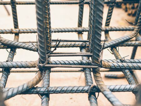Vintage style photo of selective focused steel rods in reinforced concrete footing and column...
