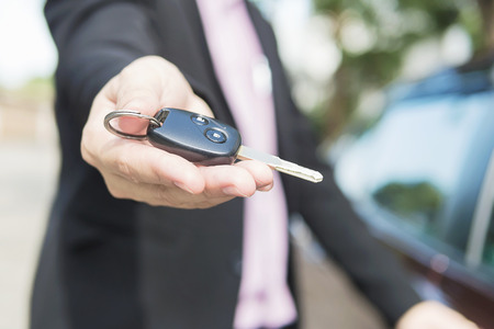 Man is giving a car key to somebodyの写真素材
