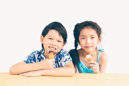 Vintage style photo of asian kids are eating ice creamの写真素材