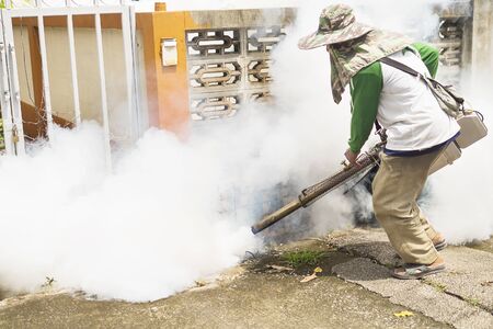 Man is using thermal fog machine to protect mosquito spreadingの写真素材