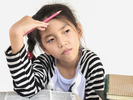 Asian kid is thinking while reading book